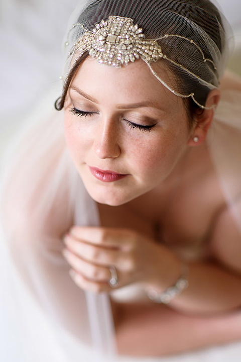Bride portrait with veiled headpiece on her wedding day.