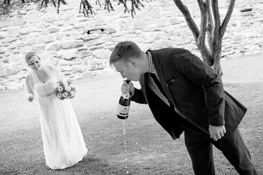 Bride and groom celebrate with champagne after intimate wedding ceremony.