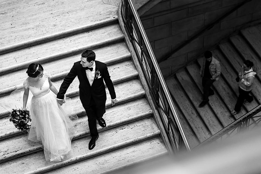 Bride and groom walking down the stairs on their wedding day.