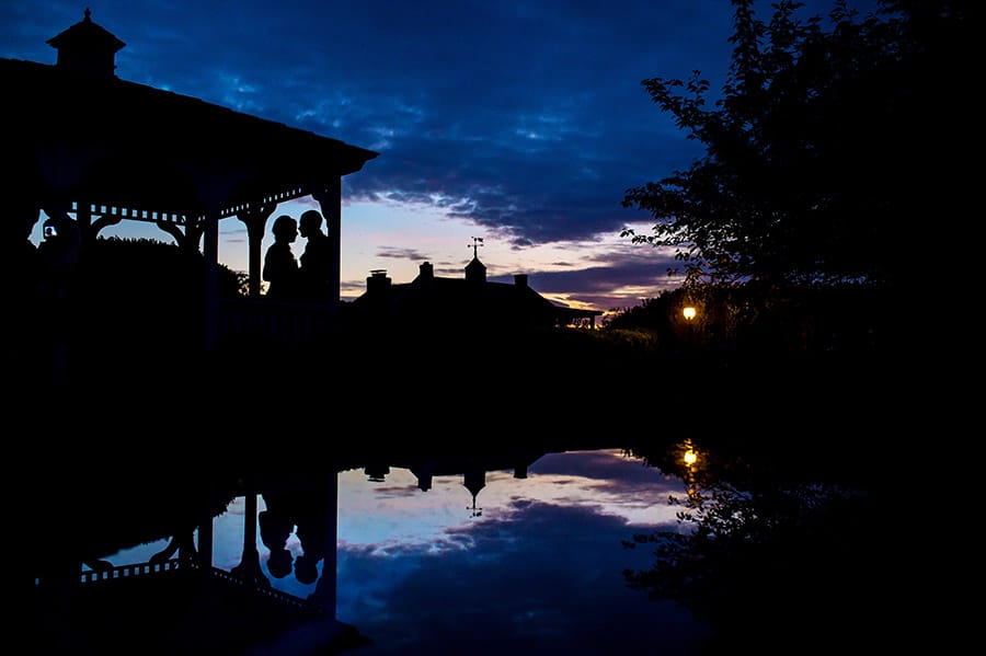 Sunset silhouette of a bride and groom under a gazebo at Antrim 1844 in Taneytown, MD.