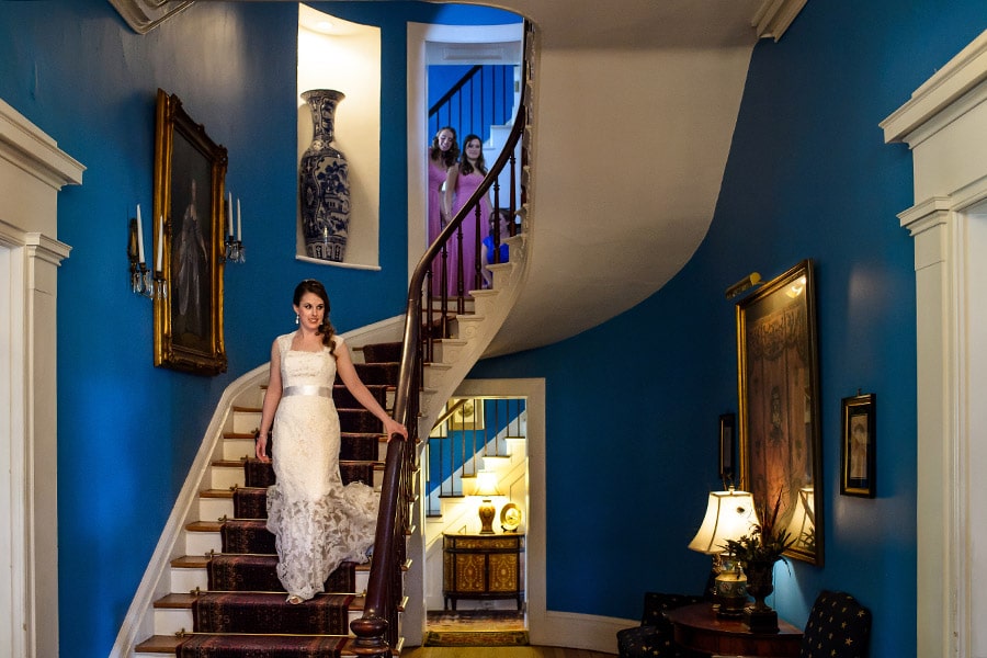 Bride descends staircase at Antrim 1844 in Taneytown, MD.