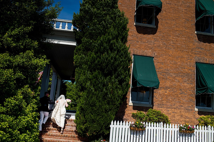 Bride and groom walk up stairs into Antrim 1844 in Taneytown, MD.