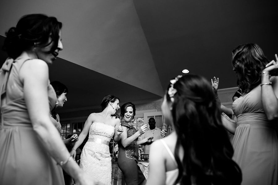 Bride and bridesmaids dance at the wedding reception.