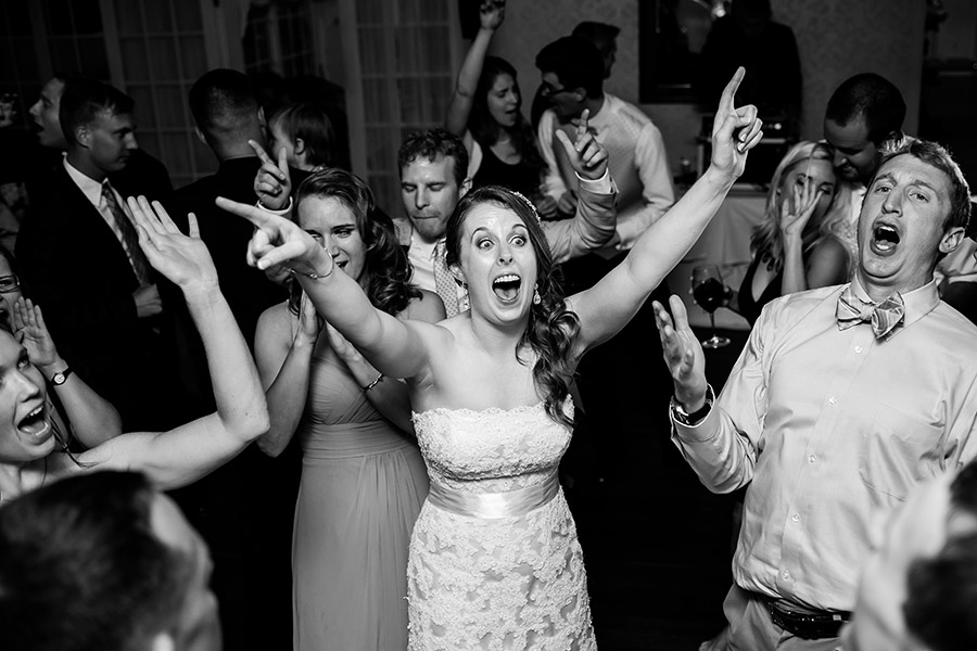 Bride singing and shouting during wedding reception.