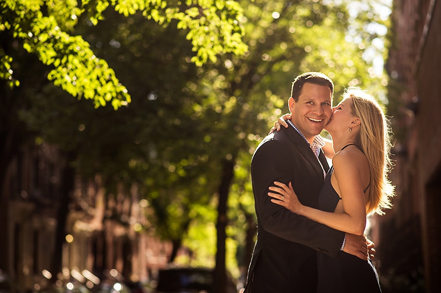 Bride-to-be kissing her groom-to-be on the cheek during their NYC engagement session.