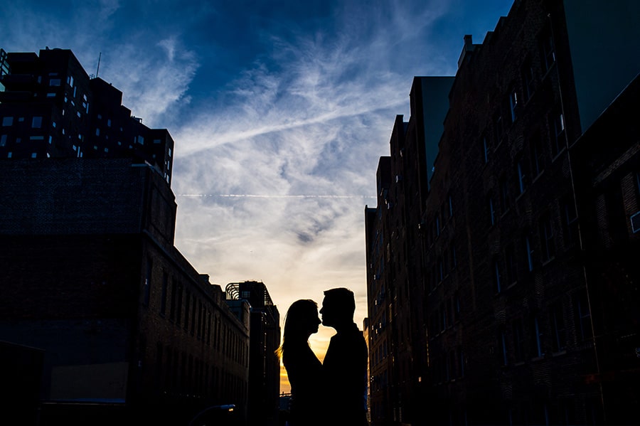 Sunset silhouette of an engaged couple on the NYC Highline.