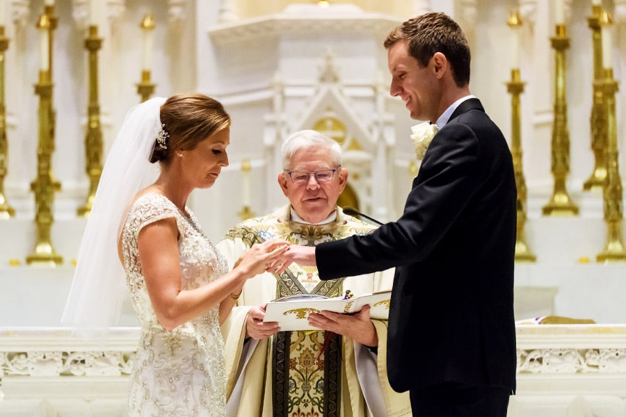 Bride and groom exchange rings in Philadelphia wedding ceremony.