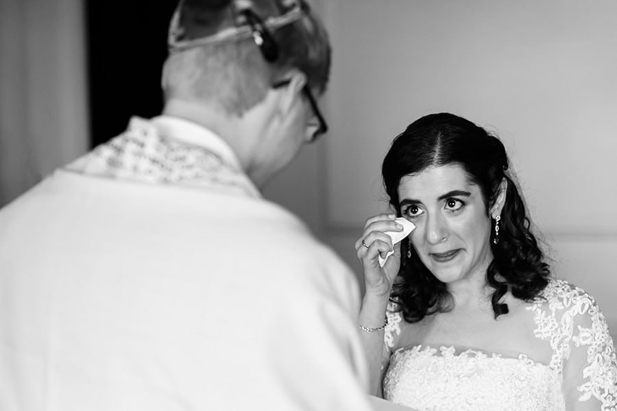 Bride wipes tears away as groom says his wedding vows in Jewish ceremony at the Downtown Club in Philadelphia.