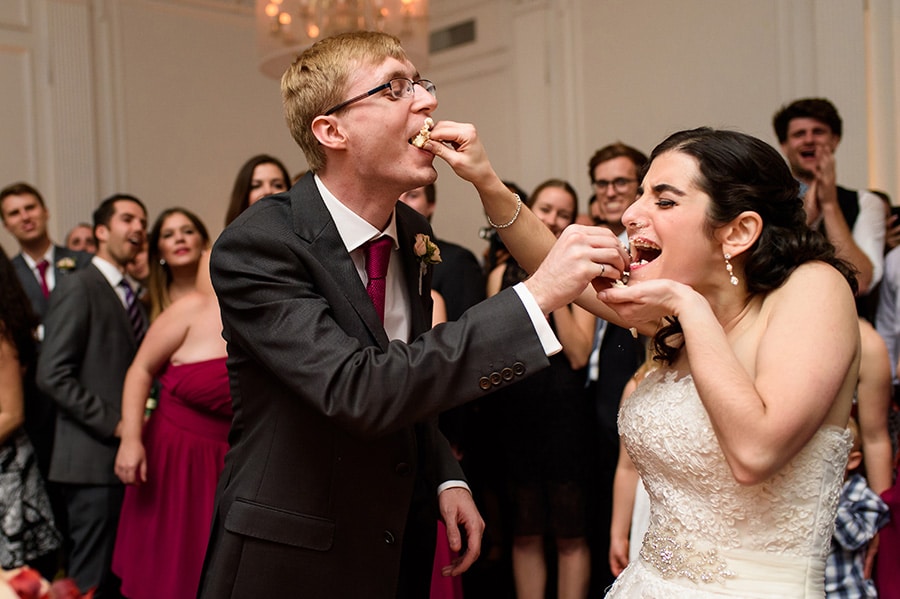 Bride and groom shove cake into each other's face!