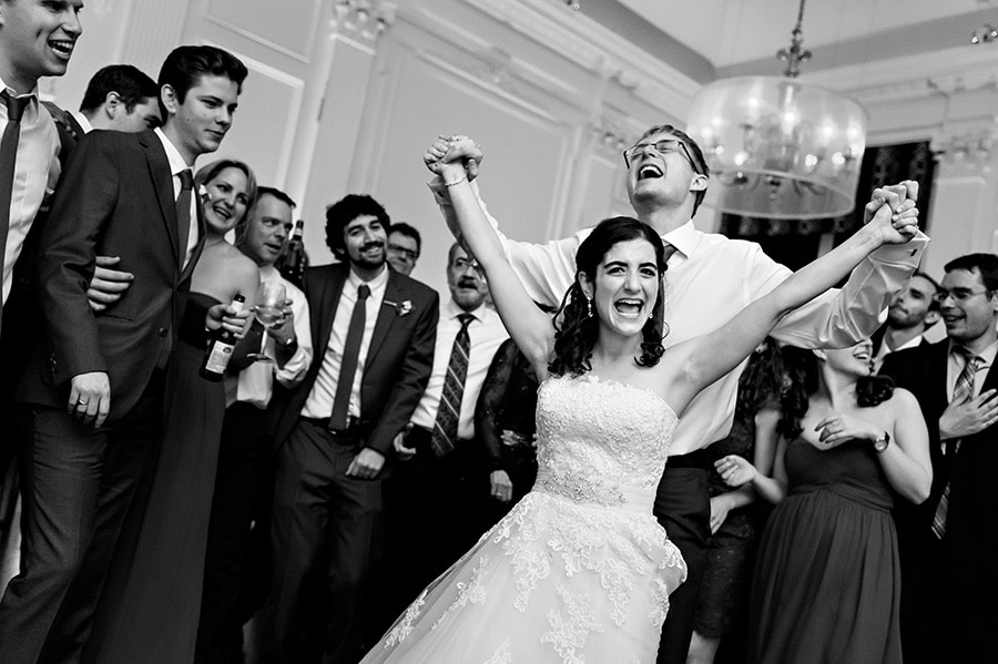 Groom holds brides hands in the air as they sing the last song!