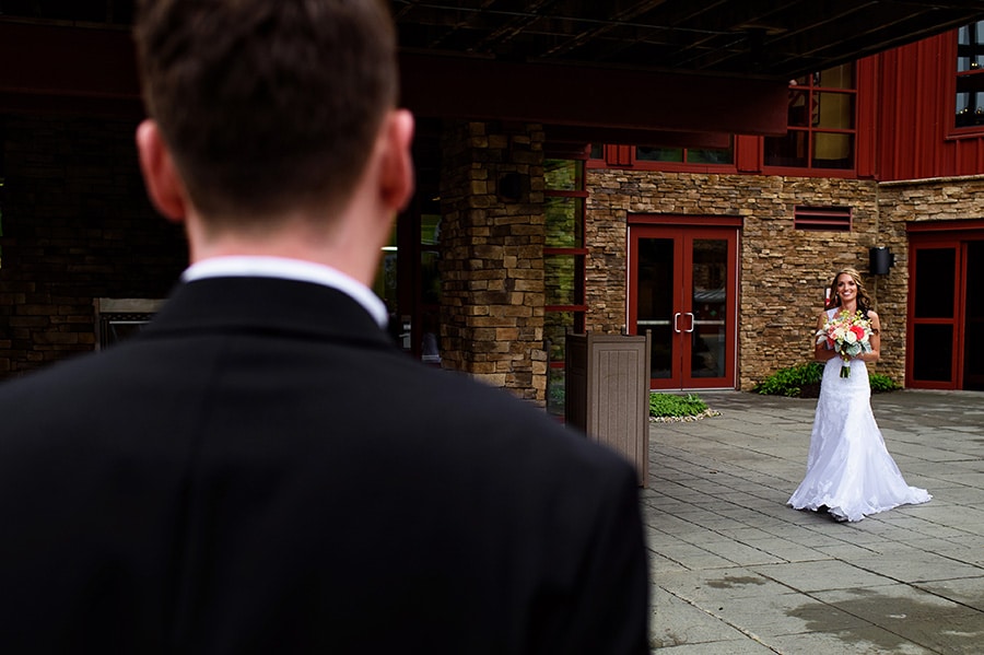 Bride walks to tearful groom during their wedding ceremony at Bear Creek Mountain Resort.