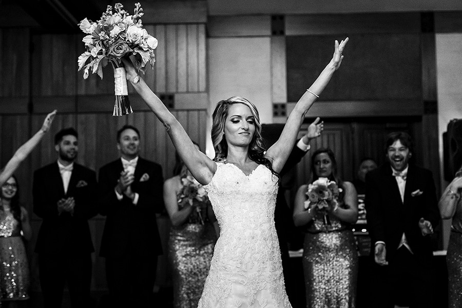 Excited bride throws her hands in the air as she enters reception at Bear Creek Mountain Resort.