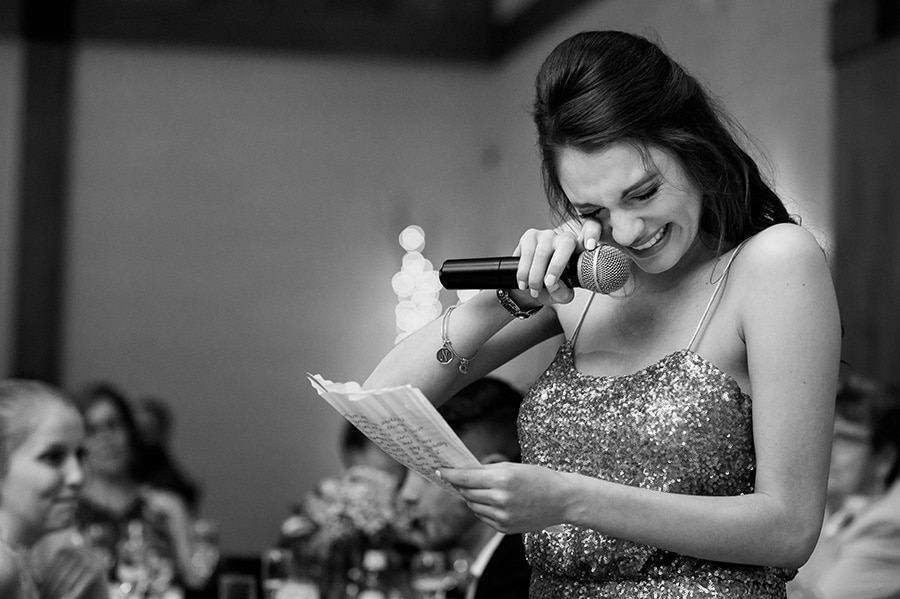 Maid of honor wipes tears away during toast at Bear Creek.