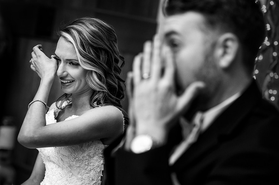 Bride and groom wipe tears from their eyes during wedding speech!